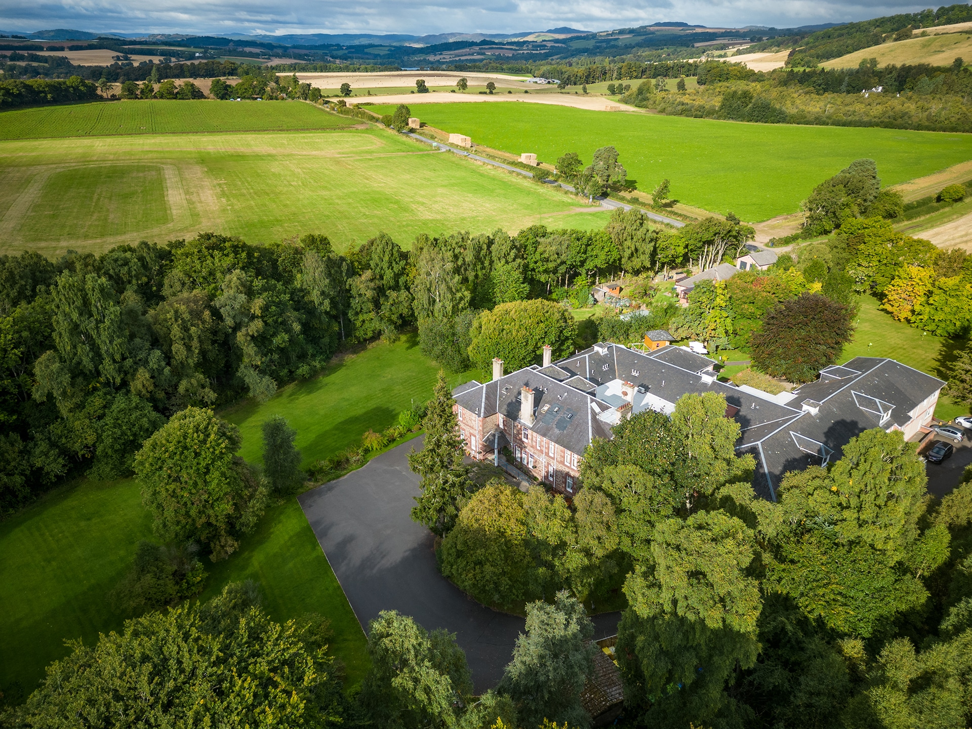 An aerial view of Muirton House Care Home and the rolling hills in the background.