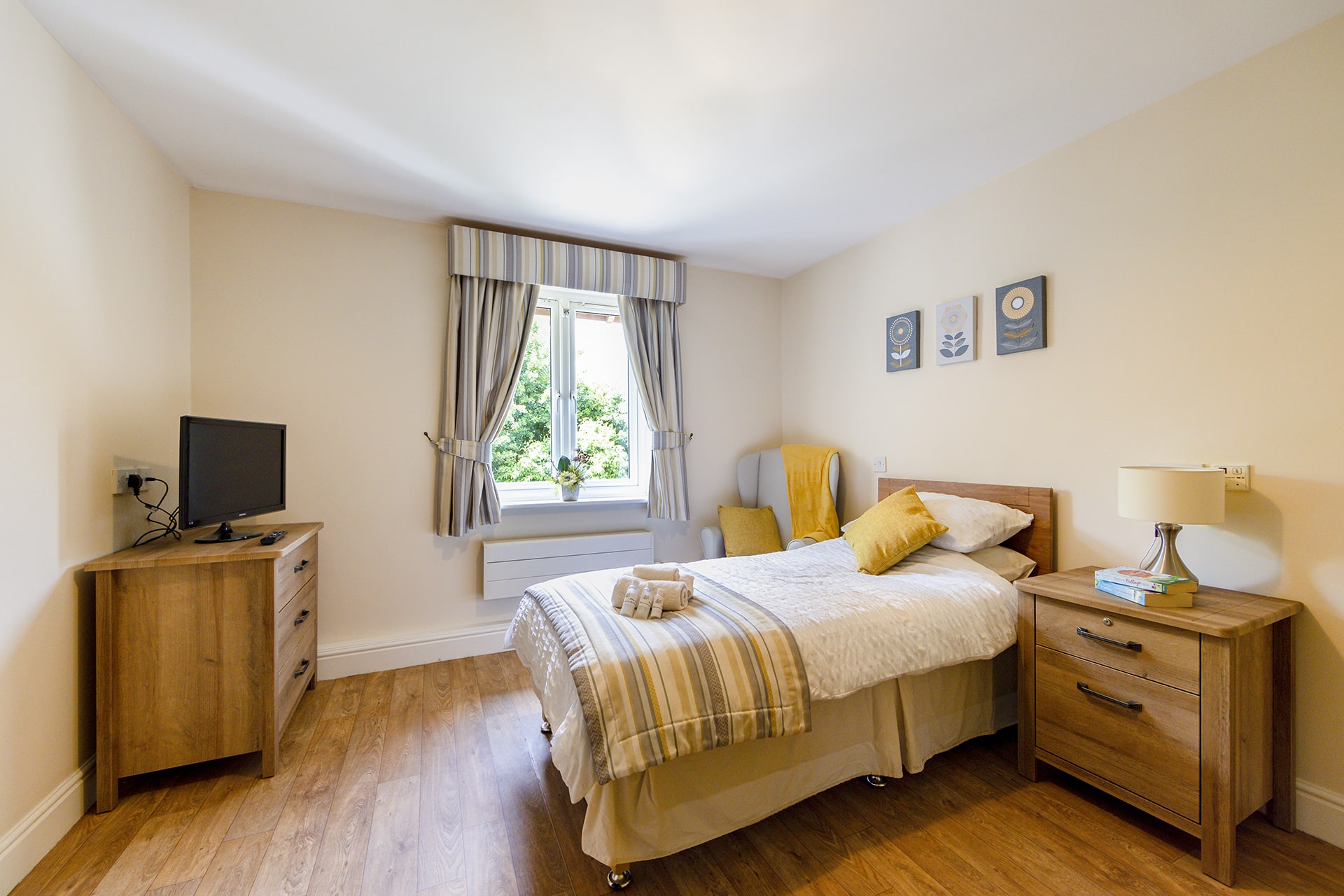 Bedroom with cream and yellow decor at Lily House in Ely.