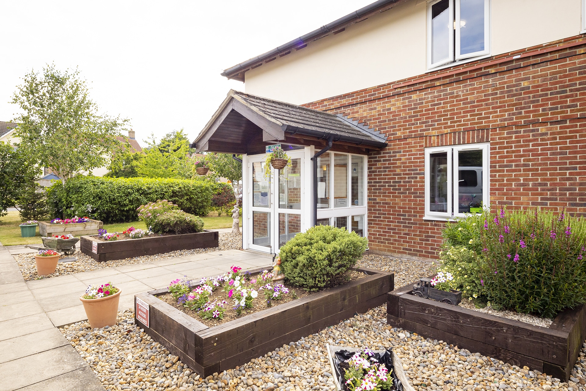 The front entrance of Lily House Care Home in Ely with a view of the home's raised planters.