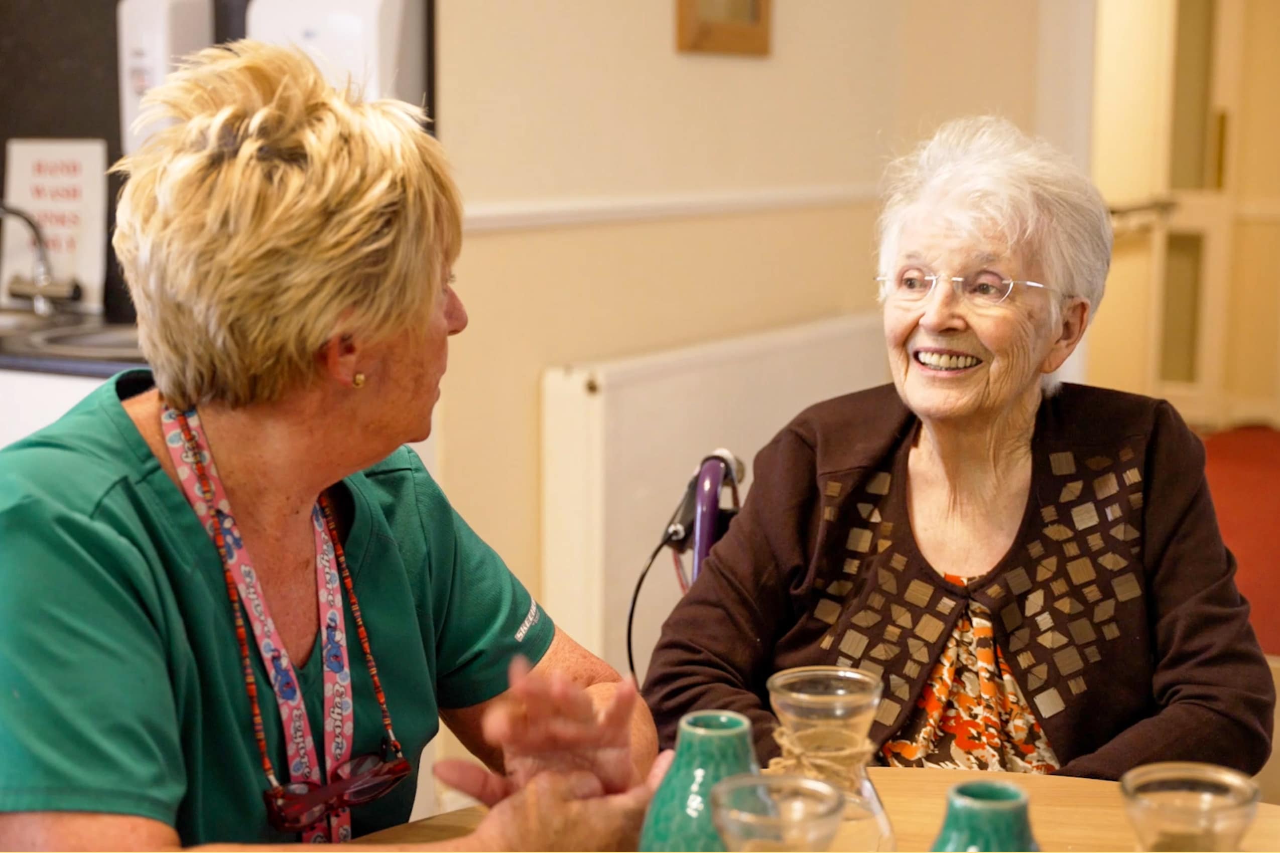 Resident and carer enjoying a chat at Muirton House Care Home.