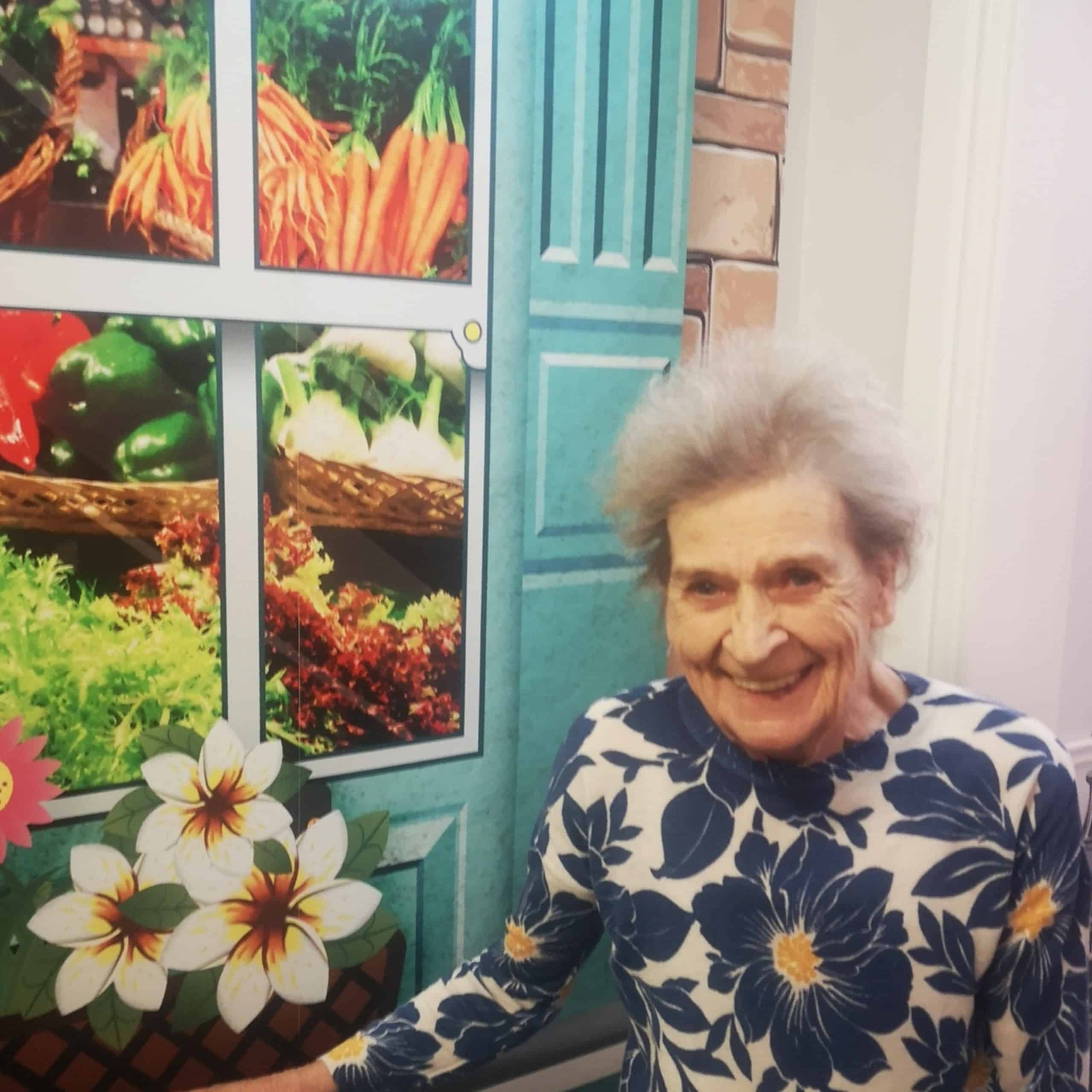 Resident Moira Buchanan enjoying the grocery store mural at Avonbridge Care Home in Hamilton.