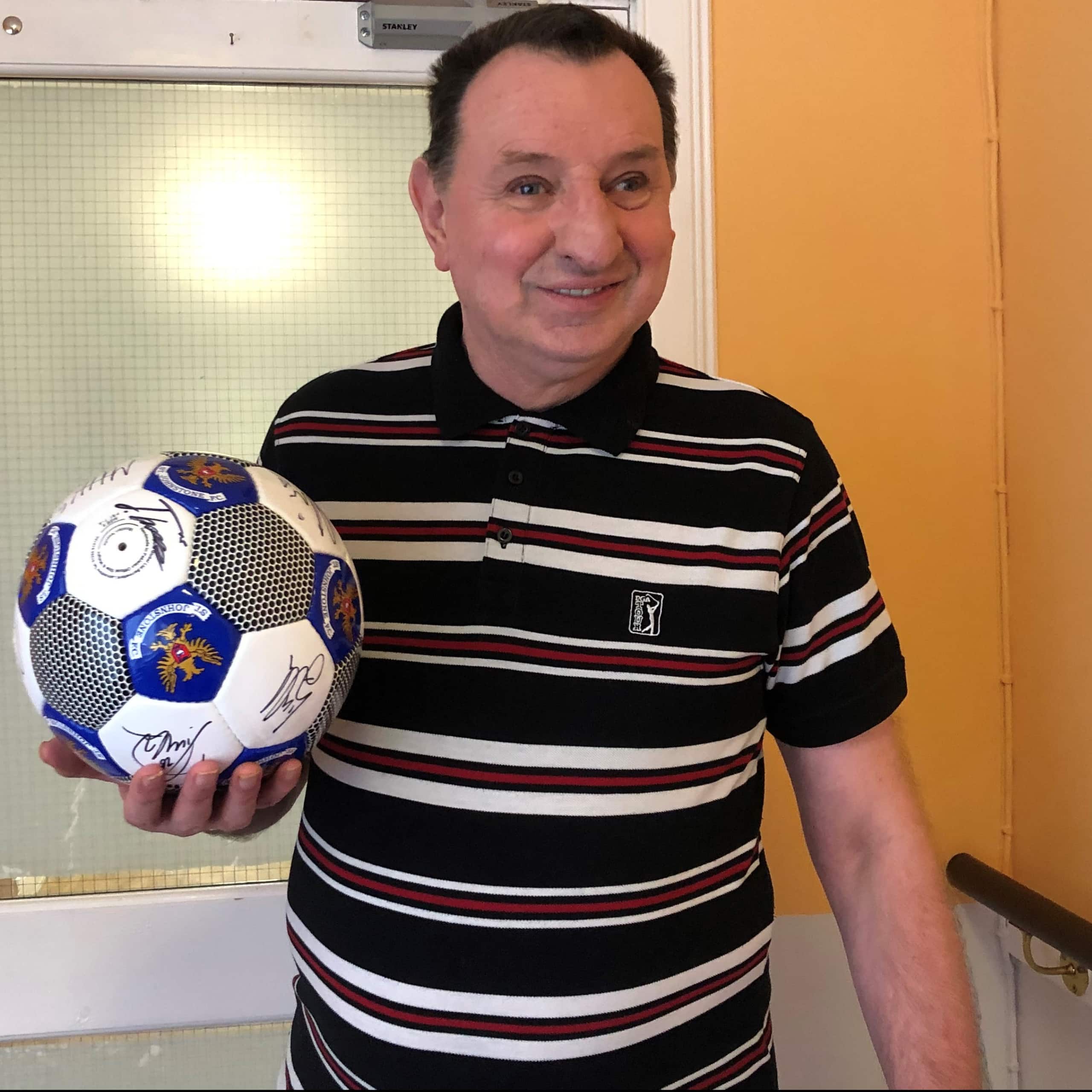 A resident at Blairgowrie Care Home Muirton House shows off his gift from St Johnstone Football Club.