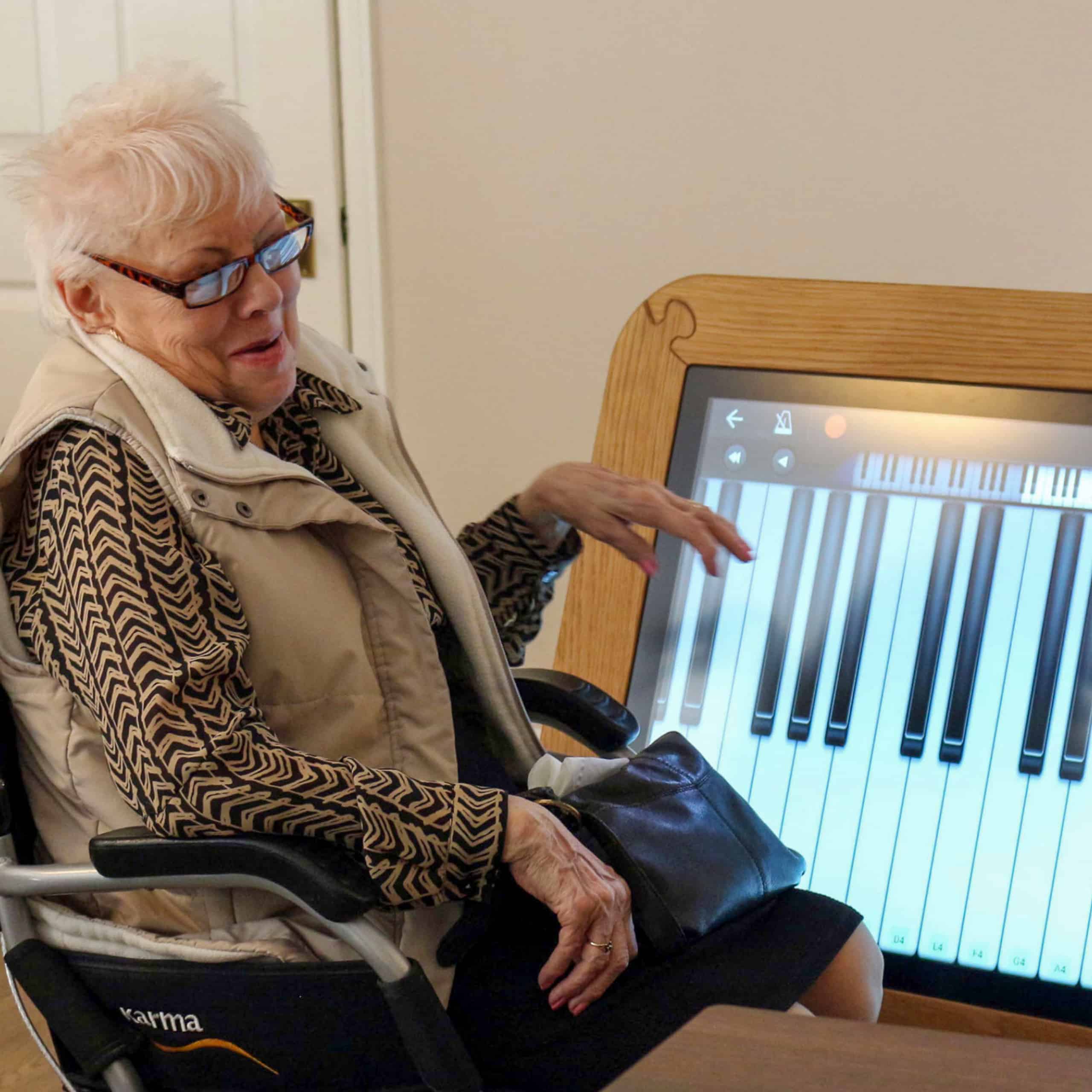 Great Horkesley Manor resident Shirley Wyncoll with the giant interactive table at the care home in Colchester.