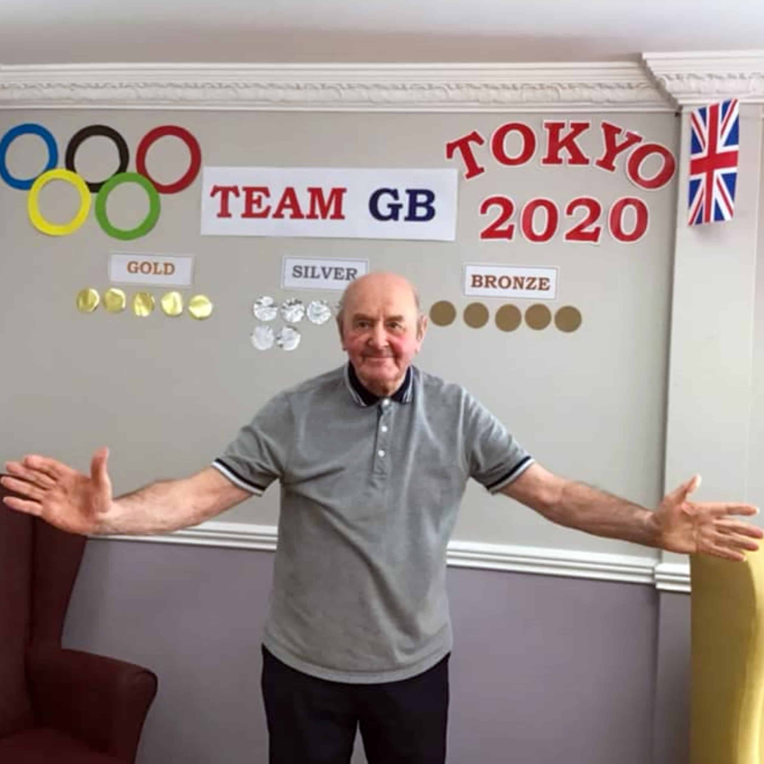 Ken, a resident of Willenhall care home Swan House with the home's Team GB medal board.