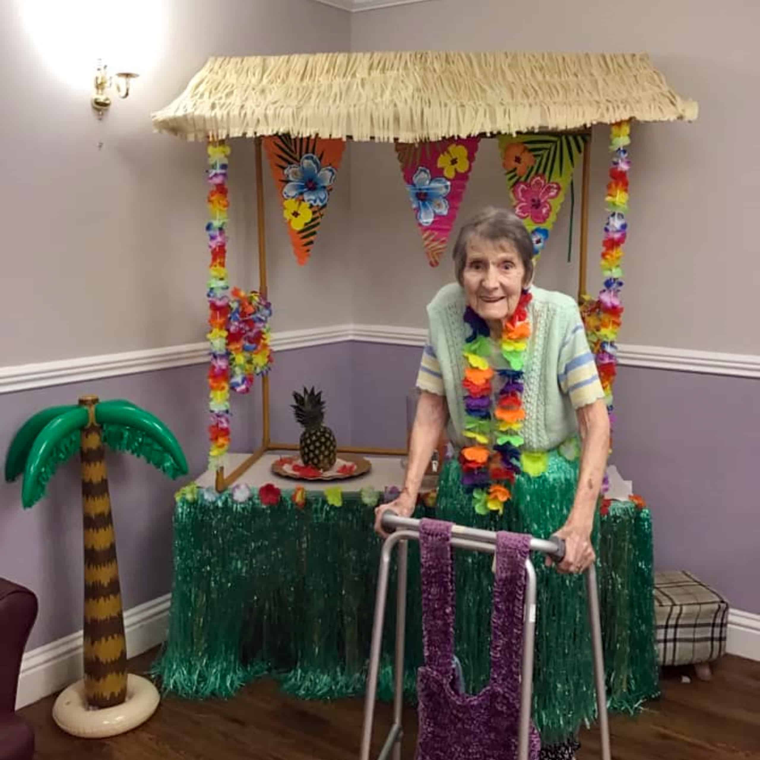 A resident at Swan House Care Home in Willenhall enjoying the home's decorations for their Hawaiian-theme day.