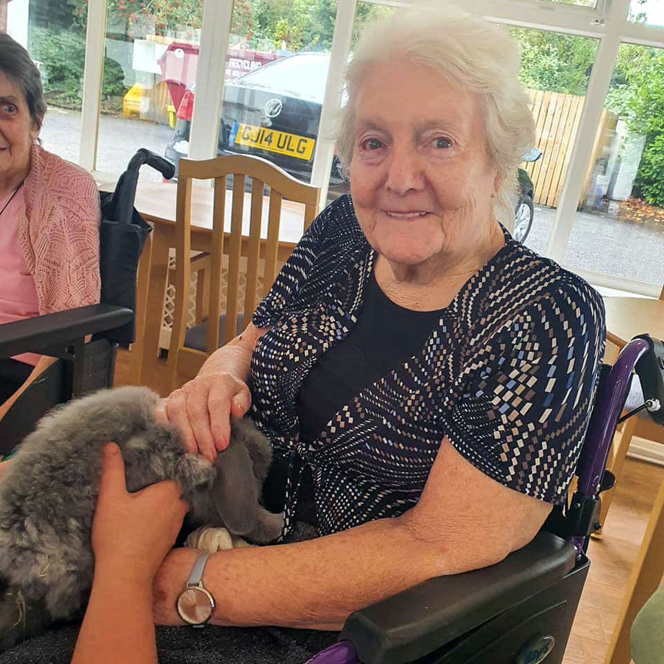A resident at Avonbridge Care Home in Hamilton with on of the Bunny & Co therapy pets.